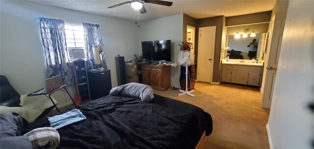 carpeted bedroom with cooling unit, ceiling fan, sink, and connected bathroom