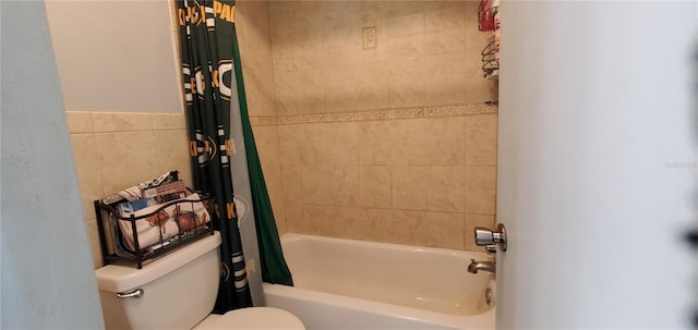 bathroom featuring tile walls, toilet, and shower / bath combo