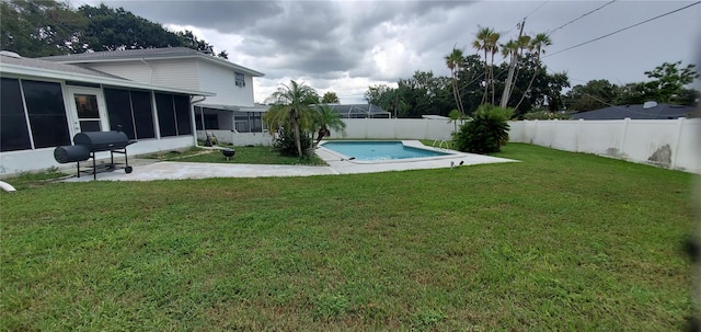 view of yard featuring a fenced in pool and a sunroom