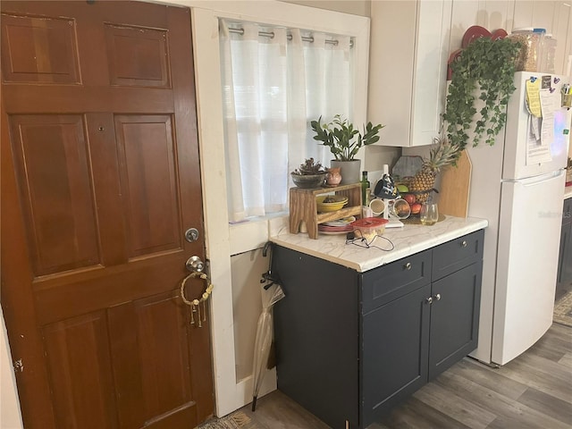 1874 Douglas Ave, Clearwater, FL 33755 - interior space with light countertops, wood finished floors, and freestanding refrigerator