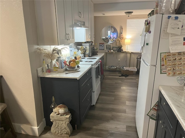 1874 Douglas Ave, Clearwater, FL 33755 - kitchen featuring white appliances, light countertops, under cabinet range hood, and dark wood-type flooring