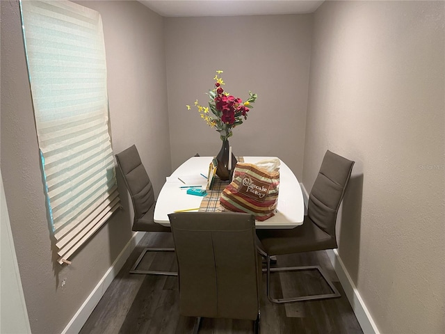 dining space with dark hardwood / wood-style floors