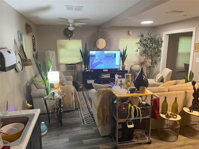 living room featuring hardwood / wood-style floors, cooling unit, and ceiling fan