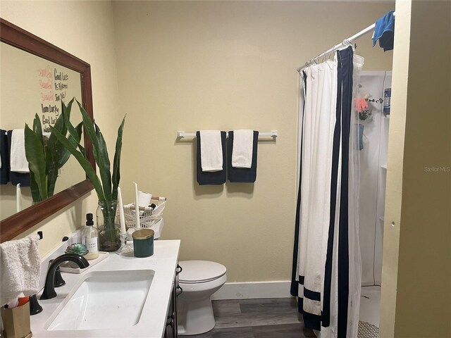 1874 Douglas Ave, Clearwater, FL 33755 - bathroom with a shower with curtain, vanity, toilet, baseboards, and wood finished floors