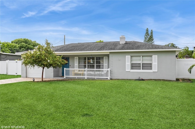 ranch-style home with a garage, a front yard, and a porch