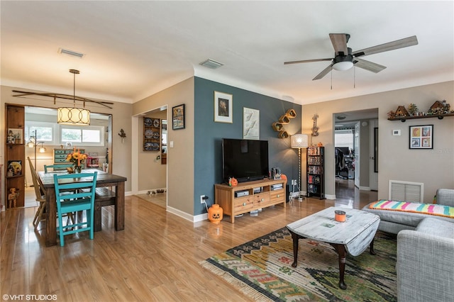 living room with ceiling fan and hardwood / wood-style flooring