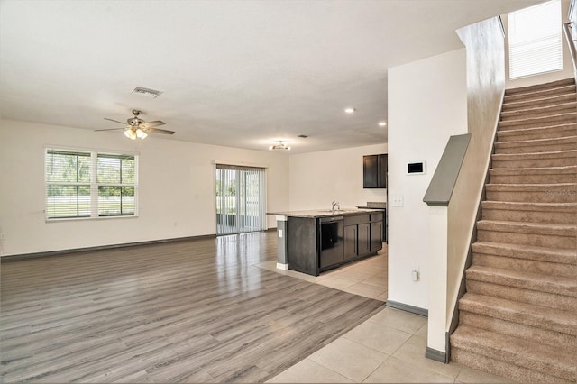 kitchen with a kitchen island with sink, ceiling fan, sink, and light hardwood / wood-style floors