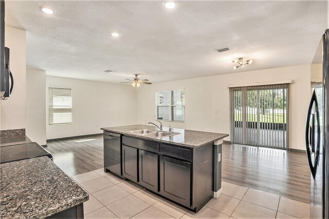 kitchen featuring plenty of natural light, sink, appliances with stainless steel finishes, and a kitchen island with sink