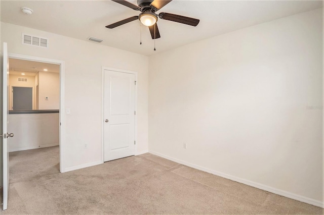 unfurnished bedroom featuring ceiling fan and light carpet