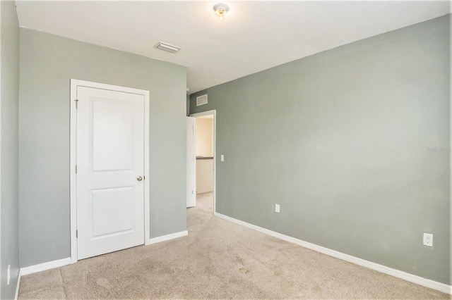 unfurnished bedroom featuring light carpet