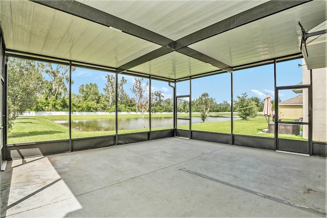 unfurnished sunroom with a water view