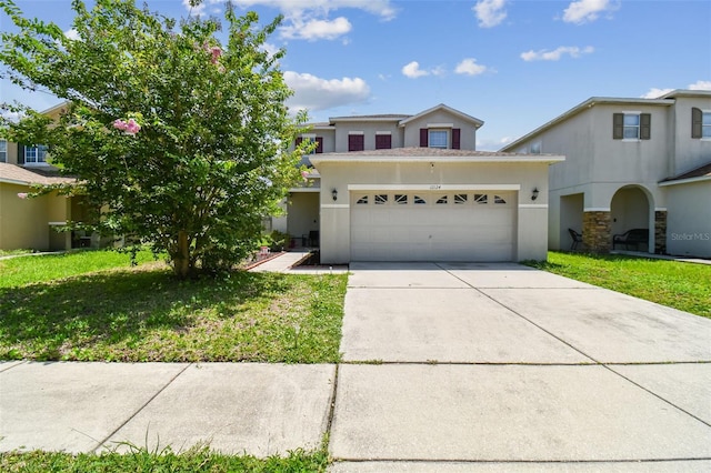 view of front of property featuring a front yard and a garage