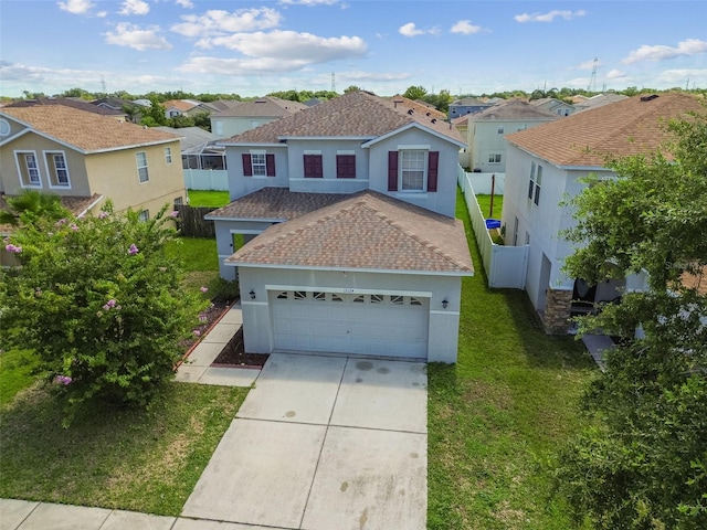 view of front of house with a front yard and a garage