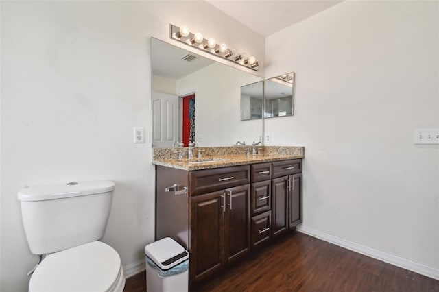 bathroom with vanity, toilet, and hardwood / wood-style flooring