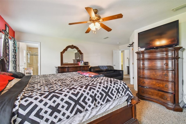 carpeted bedroom featuring ceiling fan and ensuite bathroom