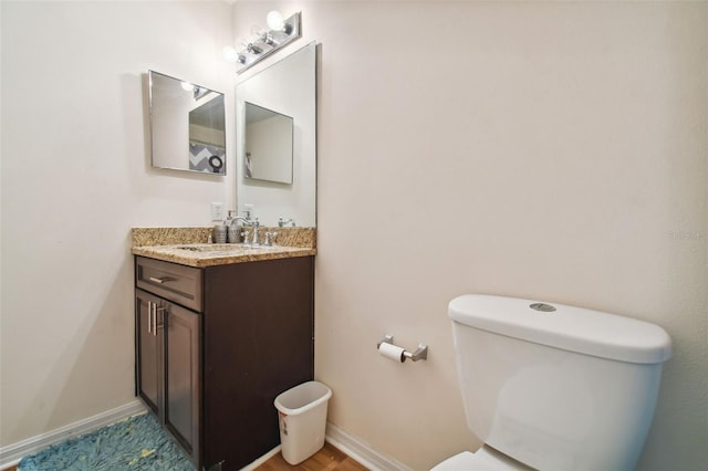 bathroom featuring toilet and vanity