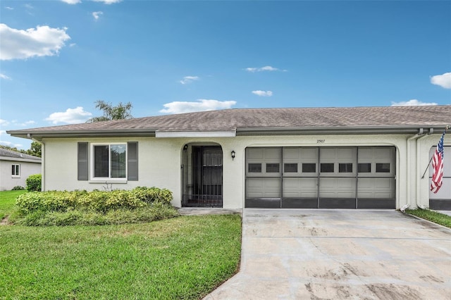 ranch-style house with driveway, stucco siding, a front yard, and an attached garage