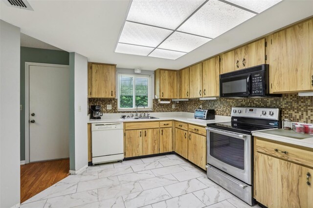 kitchen with marble finish floor, a sink, stainless steel range with electric cooktop, white dishwasher, and black microwave