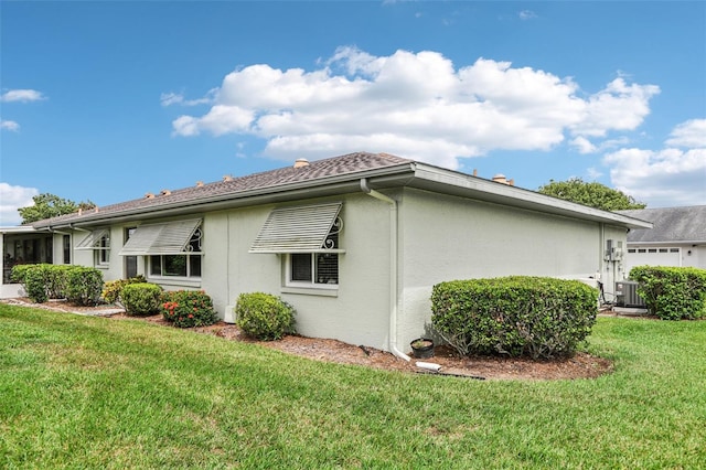 view of home's exterior with a lawn and central air condition unit