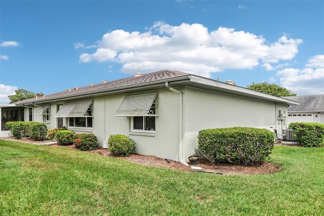 view of property exterior featuring central AC unit, stucco siding, and a yard