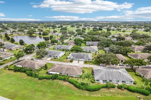 drone / aerial view with a water view and a residential view