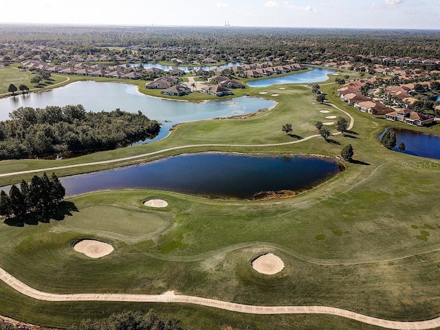 drone / aerial view with a water view and view of golf course