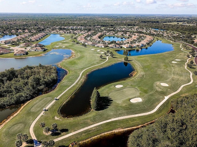 aerial view with golf course view and a water view