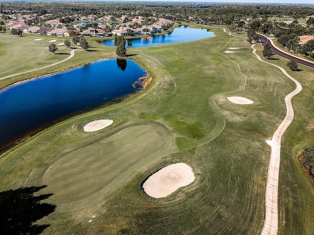 aerial view featuring view of golf course and a water view