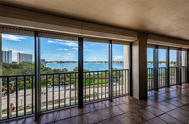 7037 Sunset Dr S Unit 602, South Pasadena, FL 33707 - entryway with a textured ceiling and a water view