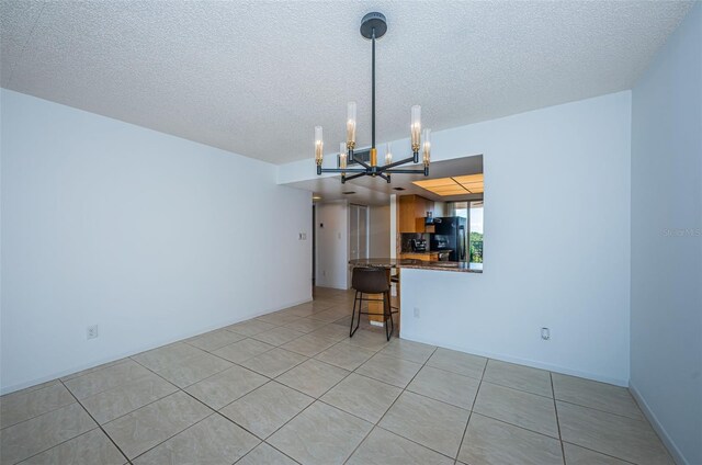 7037 Sunset Dr S Unit 602, South Pasadena, FL 33707 - interior space with light tile patterned flooring, an inviting chandelier, and a textured ceiling