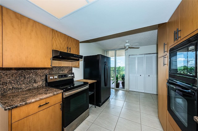 7037 Sunset Dr S Unit 602, South Pasadena, FL 33707 - kitchen with light tile patterned floors, a ceiling fan, under cabinet range hood, black appliances, and decorative backsplash