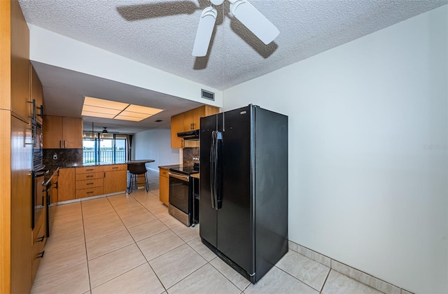 kitchen with black appliances, light tile patterned flooring, ceiling fan, and tasteful backsplash