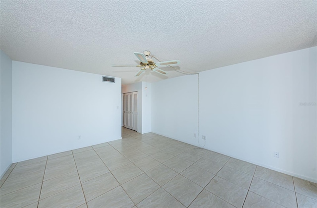 7037 Sunset Dr S Unit 602, South Pasadena, FL 33707 - empty room with light tile patterned floors, ceiling fan, visible vents, and a textured ceiling