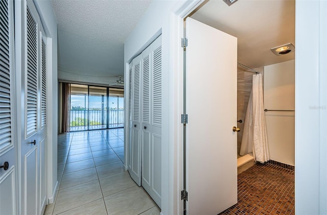 7037 Sunset Dr S Unit 602, South Pasadena, FL 33707 - hallway with light tile patterned floors