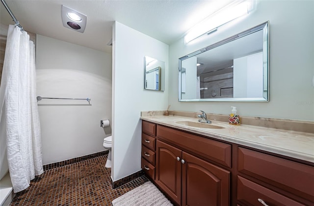 bathroom featuring vanity, toilet, tile patterned floors, and a shower with curtain