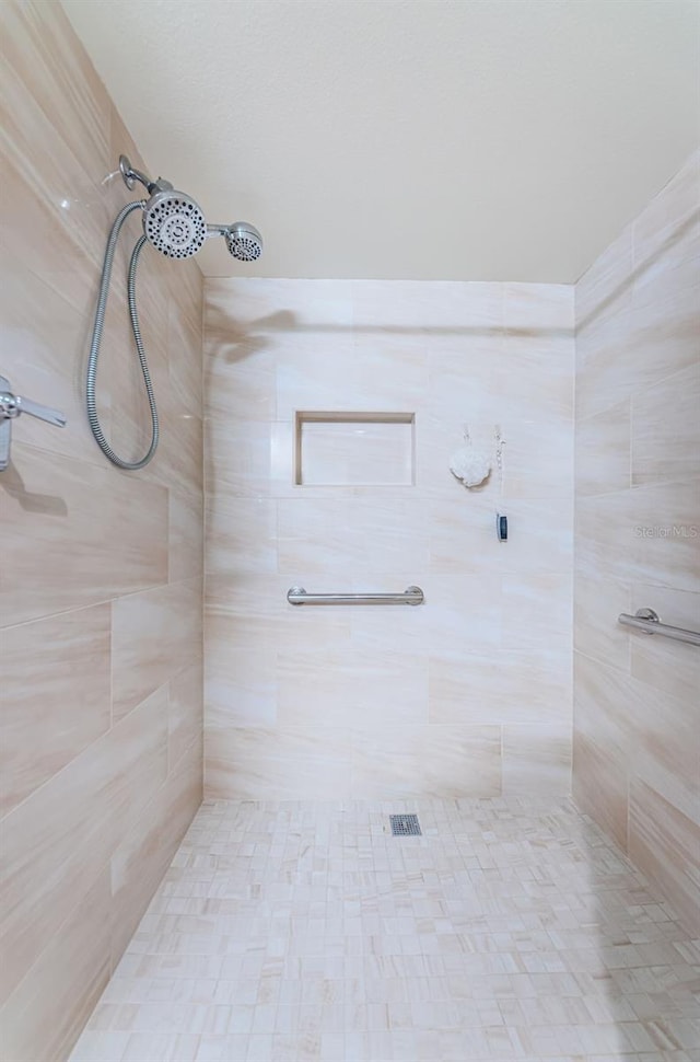 bathroom with tiled shower