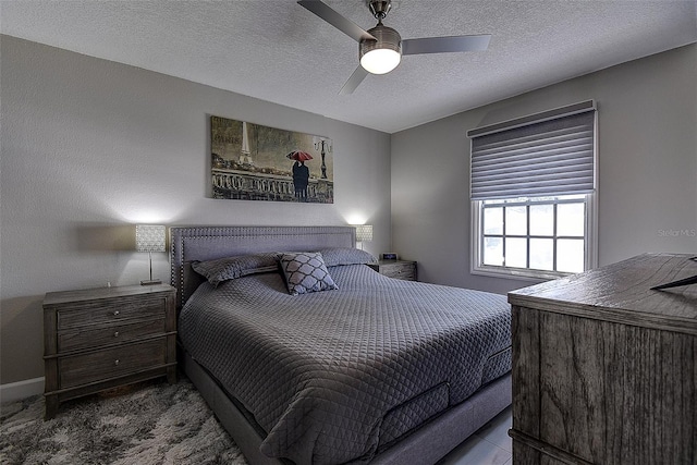 bedroom featuring a textured ceiling and ceiling fan