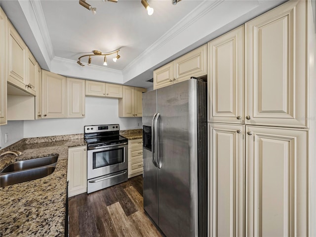 kitchen featuring stainless steel appliances, cream cabinets, dark stone counters, dark hardwood / wood-style flooring, and sink