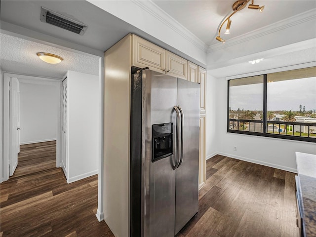 kitchen with cream cabinets, ornamental molding, a textured ceiling, stainless steel refrigerator with ice dispenser, and dark wood-type flooring