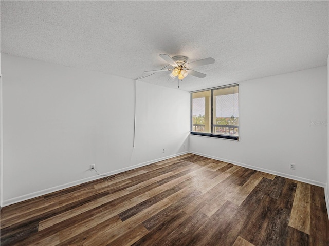 empty room with dark wood-type flooring, a textured ceiling, and ceiling fan