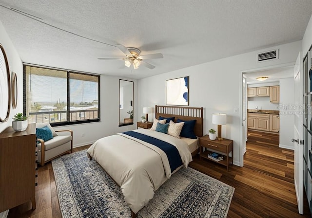 7100 Sunset Way Unit 405, St Pete Beach, FL 33706 - bedroom featuring dark wood-type flooring, baseboards, a textured ceiling, and ceiling fan