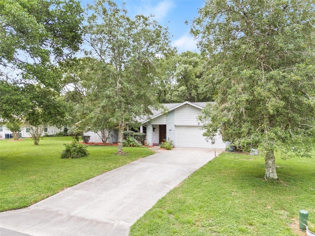 view of front of home with a front yard and a garage