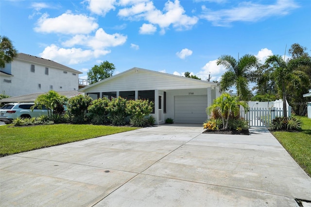 view of front of property with a front lawn and a garage