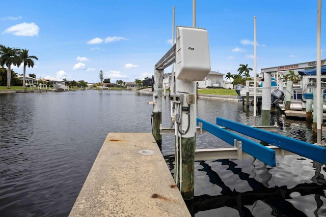 dock area with a water view and boat lift