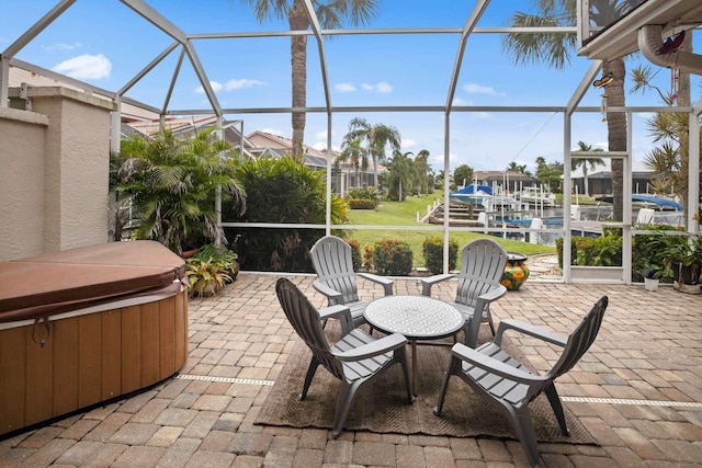 view of patio featuring a lanai and a hot tub