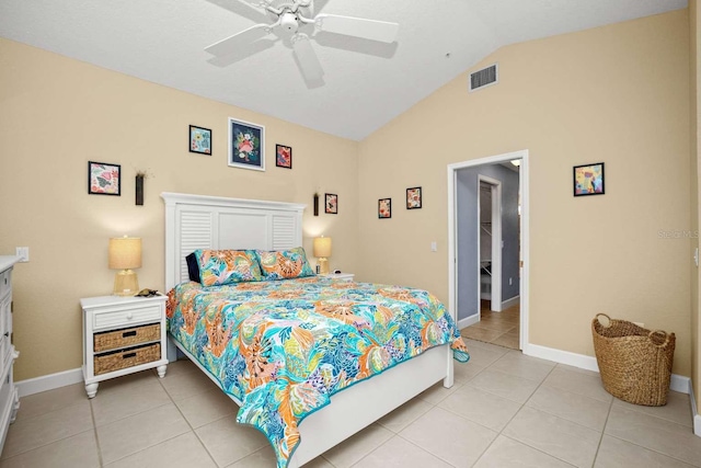 bedroom featuring ceiling fan, light tile patterned floors, and vaulted ceiling