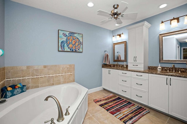 bathroom featuring tile patterned floors, a tub to relax in, ceiling fan, and vanity