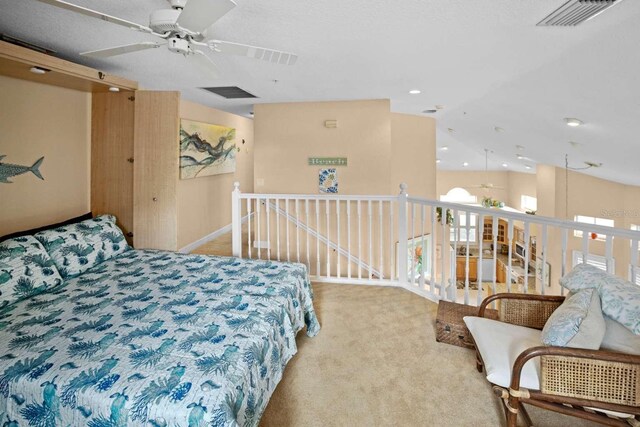 bedroom featuring lofted ceiling, carpet floors, multiple windows, and visible vents