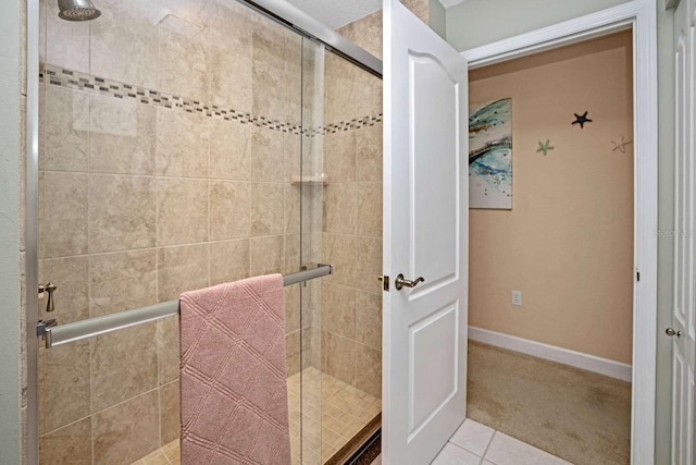 bathroom featuring tile patterned flooring and a shower with door