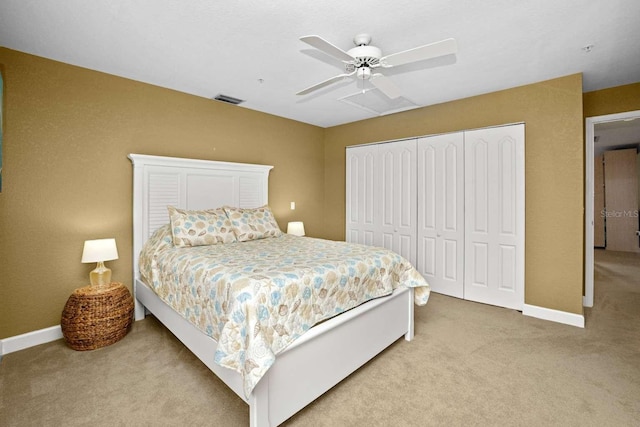 carpeted bedroom with ceiling fan and a closet